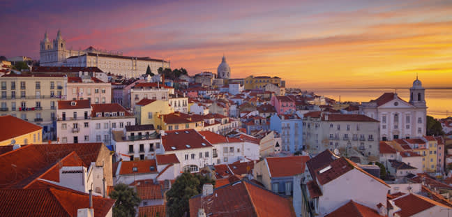 Image of Lisbon, Portugal during dramatic sunrise.