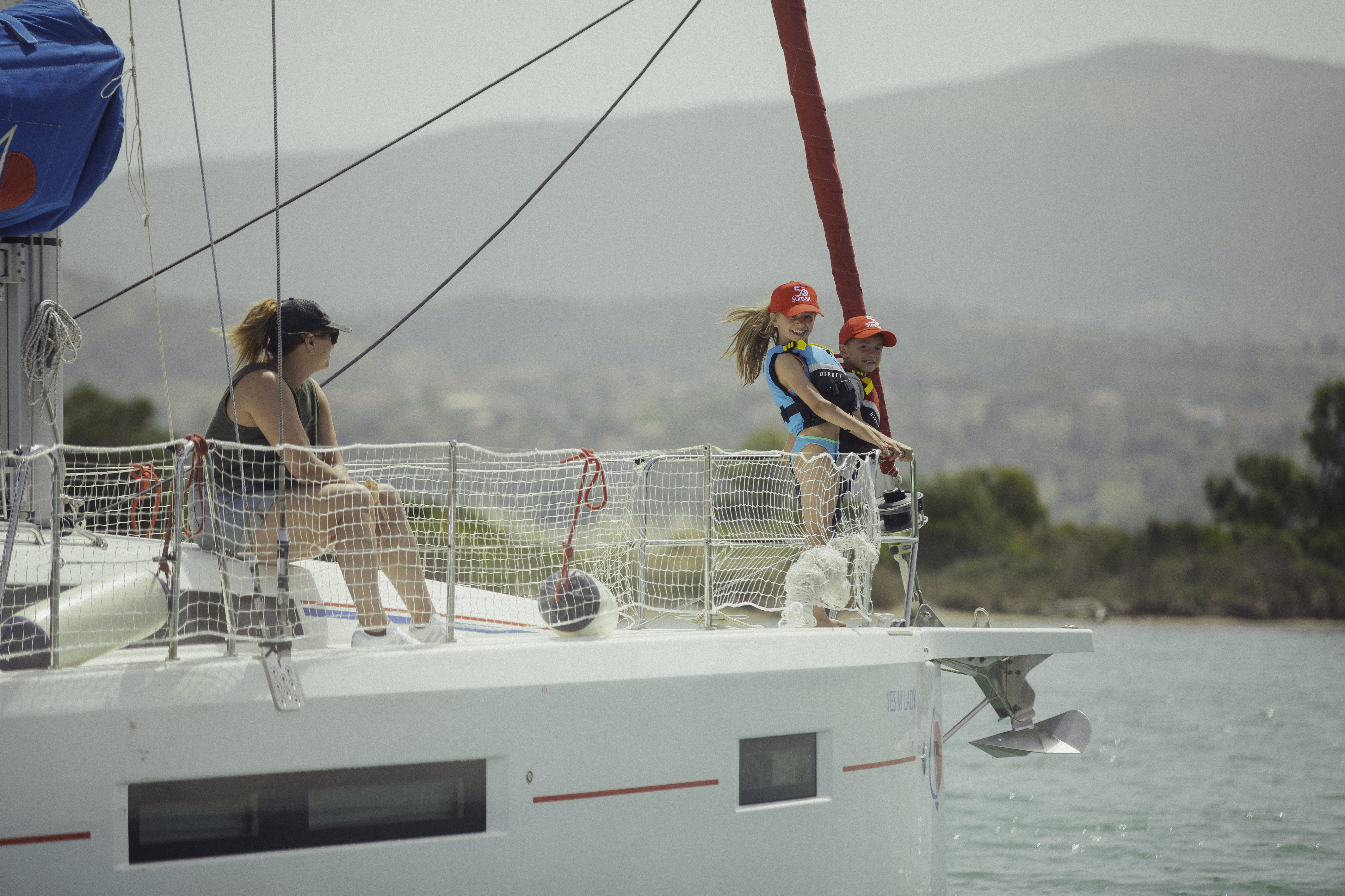 Kids enjoying the bow of the yacht