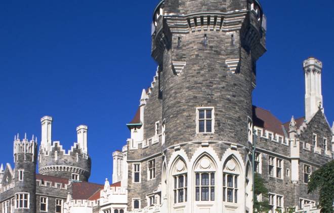 a castle with a clock at the top of a building