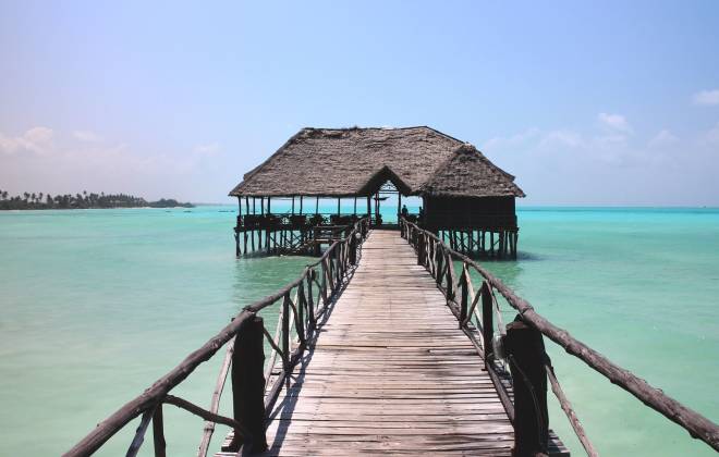 a wooden pier next to a body of water