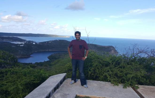 a man standing in front of a body of water