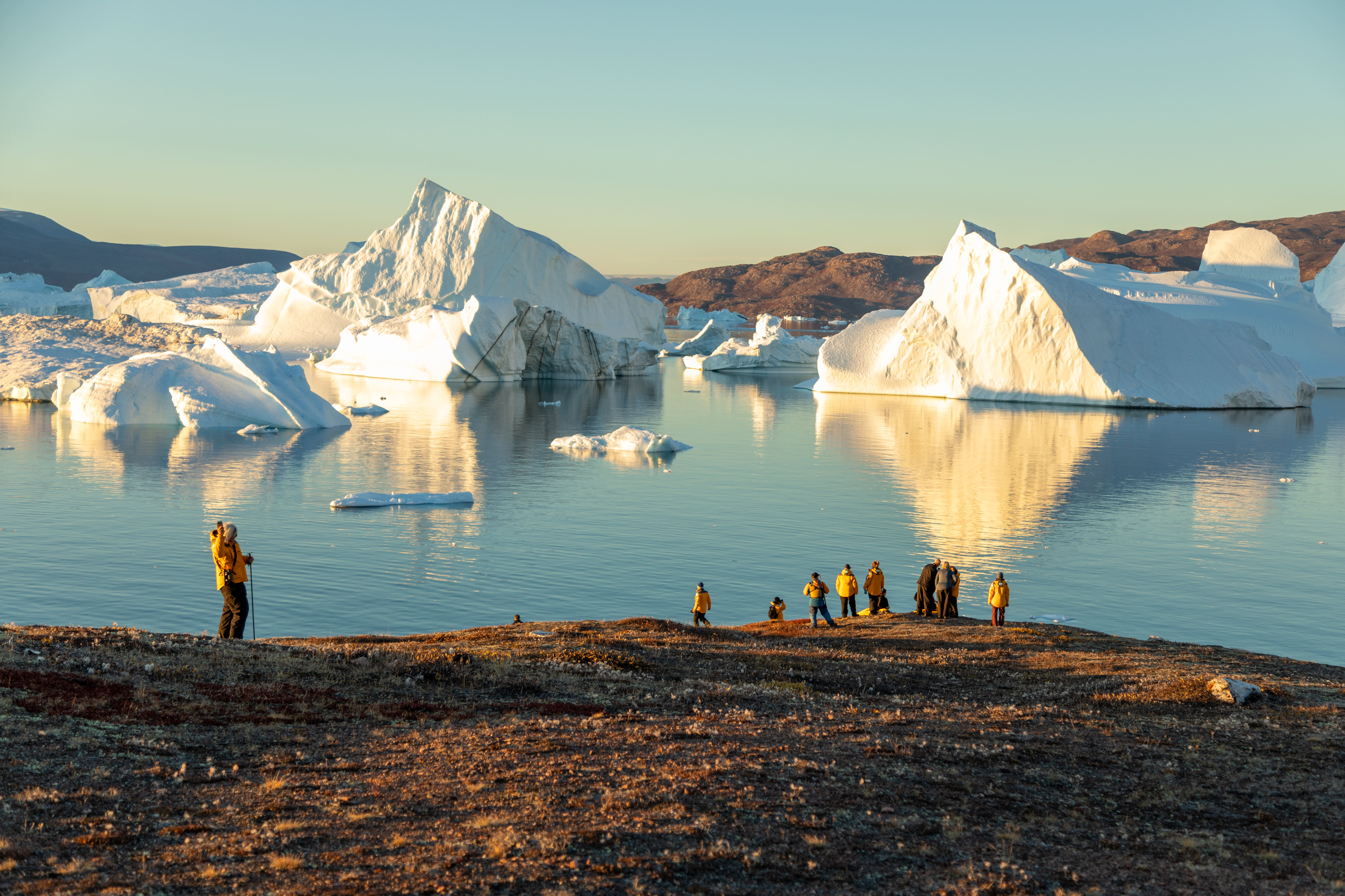 Guests enjoy a sunset landing in East Greenland. Photo by Michelle Sole.