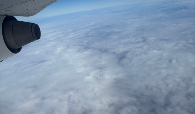 Airplane flying over clouds 
