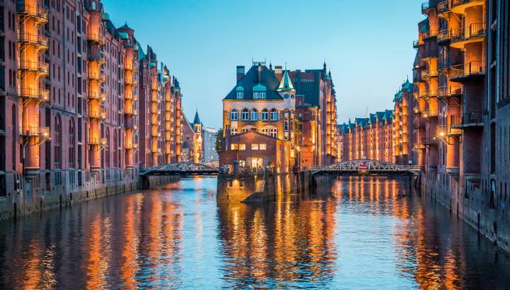 Classic view of famous Speicherstadt warehouse district, a UNESCO World Heritage Site since 2015, illuminated in beautiful post sunset twilight at dusk, Hamburg, Germany