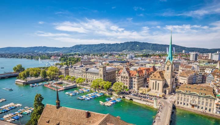 Aerial view of historic Zurich city center with famous Fraumunster Church and river Limmat at Lake Zurich from Grossmunster Church on a sunny day with clouds in summer, Canton of Zurich, Switzerland