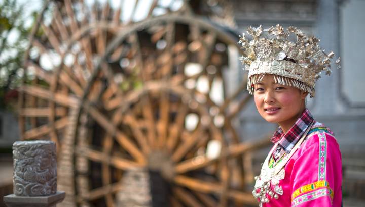 A girl dressed in ancient Chinese Miao nationality clothing. Located in Lijiang Ancient City, Yunnan Province, China