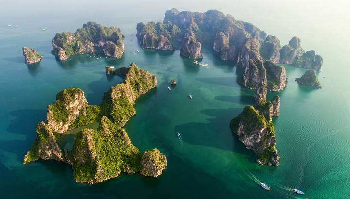 Aerial view of floating fishing village and rock island UNESCO World Heritage Site. Halong Bay, Vietnam