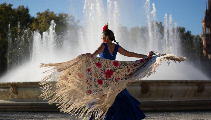 Beautiful woman dancing flamenco near the fountain