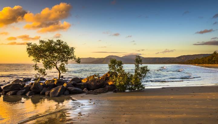 Enchanting Travels - Acolourful sunrise 4 mile beach tropical Port Douglas Coral sea clear calm ocean morning north queensland