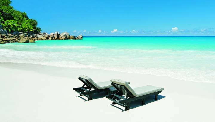 Deckchairs at the beach of Praslin Island, Seychellen