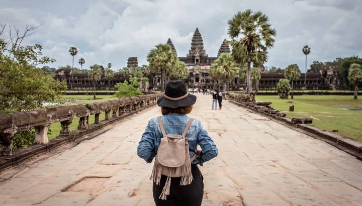 Women tourists wear jacket jeans walking into Angkor Wat landmark in Siem Reap, Cambodia, Asia