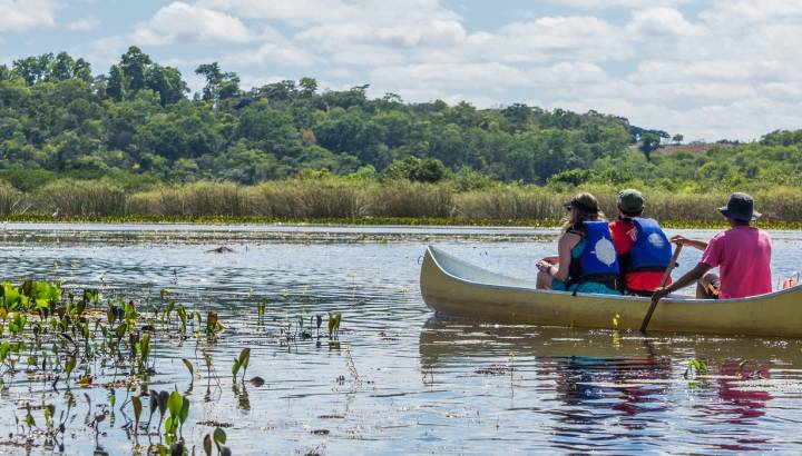 Enchanting Travels Brazil Tours Tourists with a guide in a canoe at Pantanal Marimbus (Marshland Marimbus), Chapada Diamantina, Bahia, Brazil