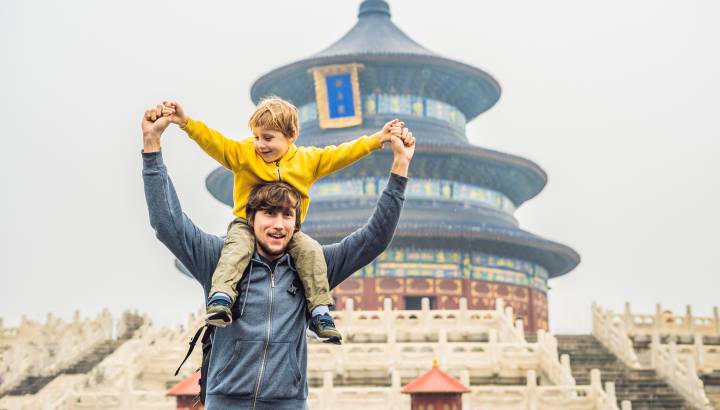 Enchanting Travels China Tours Dad and son travelers in the Temple of Heaven in Beijing. One of the main attractions of Beijing.