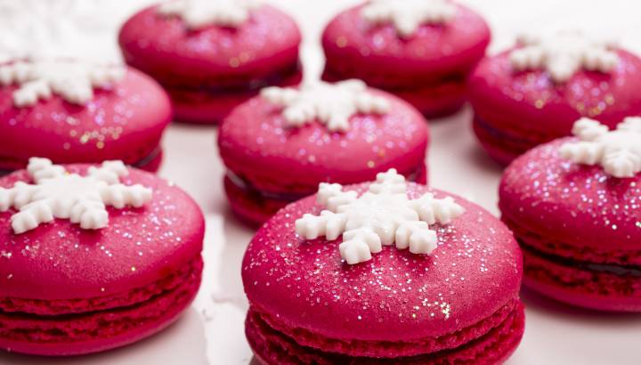 Enchanting Travels France Tours Christmas red macarons with snowflakes on top