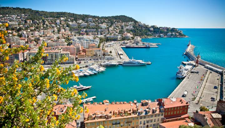 Enchanting Travels France Tours Panoramic view of Nice harbour with blue sky, France