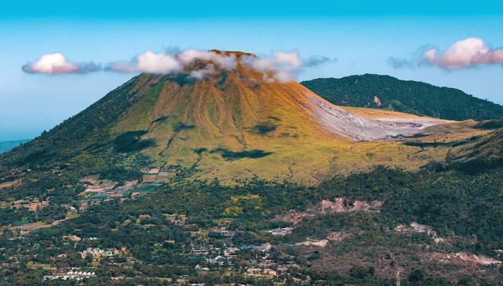 Enchanting Travels Indonesia Tours View from Mahawu volcano on the island of Sulawesi in Indonesia has a tiny crater lake.