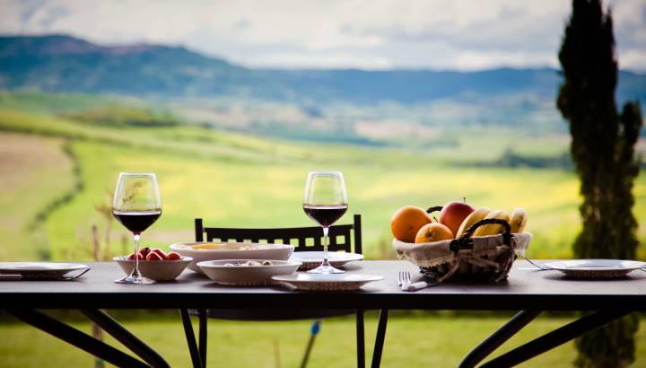 Enchanting-Travels - lunch with a view - table against beautiful landscape in Tuscany
