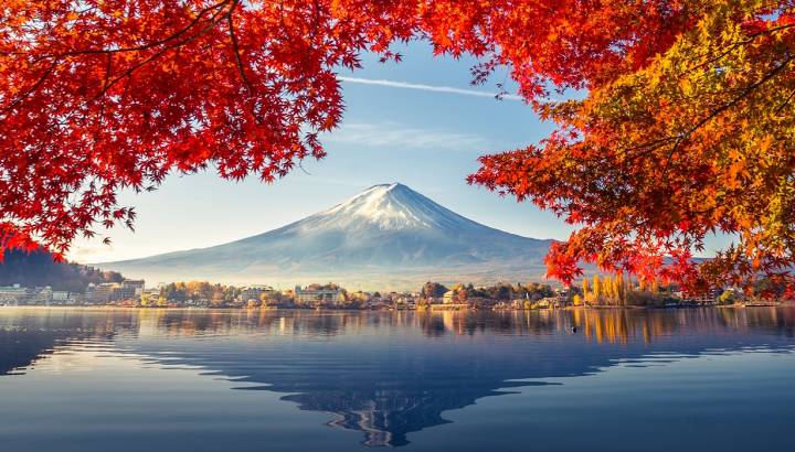 Enchanting Travels Japan Tours Colorful Autumn Season and Mountain Fuji with morning fog and red leaves at lake Kawaguchiko is one of the best places in Japan