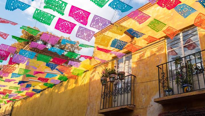 Enchanting Travels Mexico Tours Colorful paper flags over street