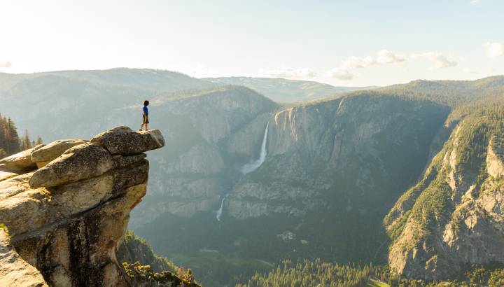 Hiker at the Glacier Point with View to Yosemite Falls and Valley
