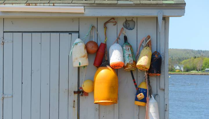 Detailaufnahme von farbigen Hummerbojen an einer Hauswand in Nova Scotia Kanada