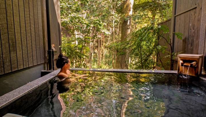 Peaceful Asian Woman in Onsen luxury spa vacation