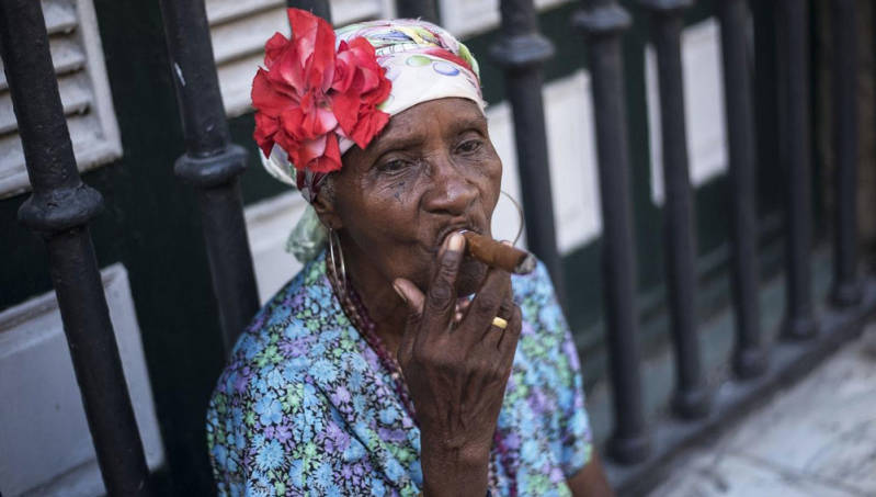 Woman in Havana smoking Cuban cigar