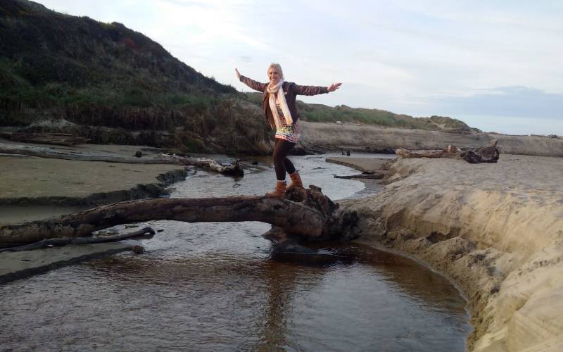 a man standing next to a body of water