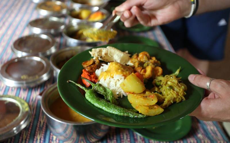 a person holding a plate of food