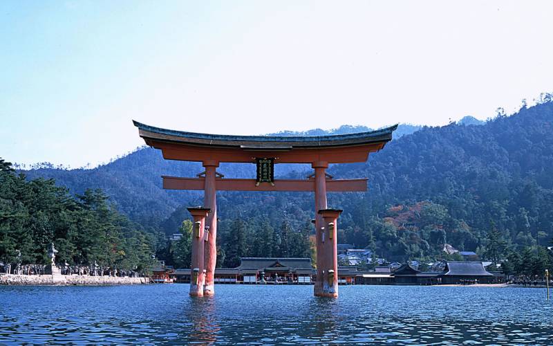 a large body of water with a mountain in the background