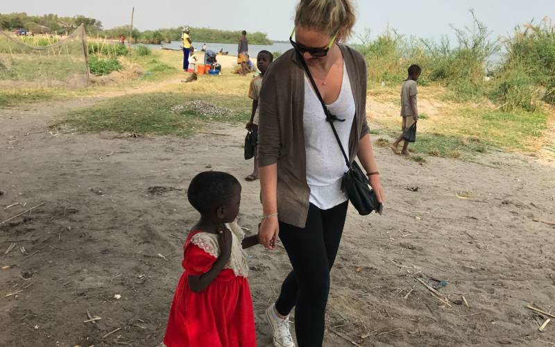 a little boy that is standing in the dirt