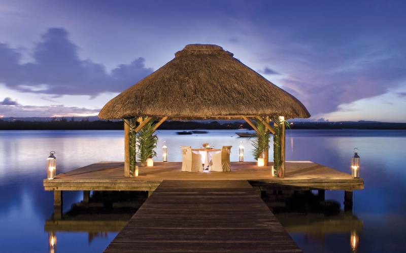 a chair sitting in front of a body of water