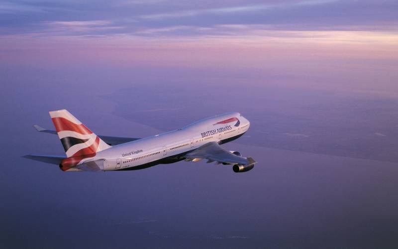 a large passenger jet flying through the air on a cloudy day