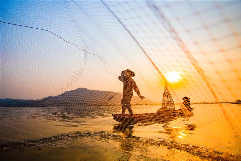 A fisherman casts his net in Vietnam