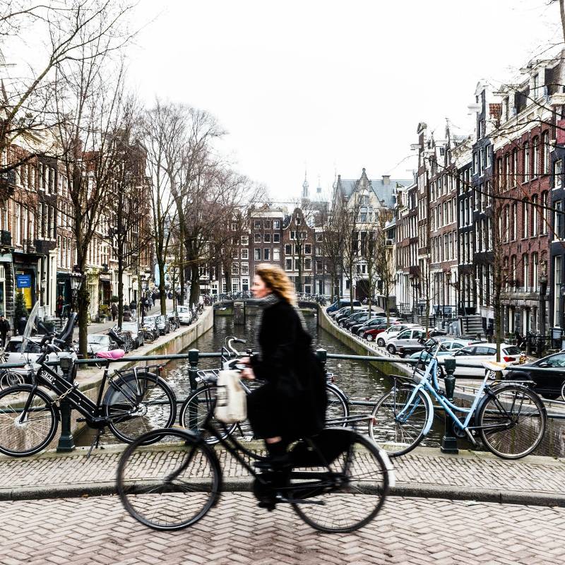 Amsterdam Cyclist traveling over a bridge