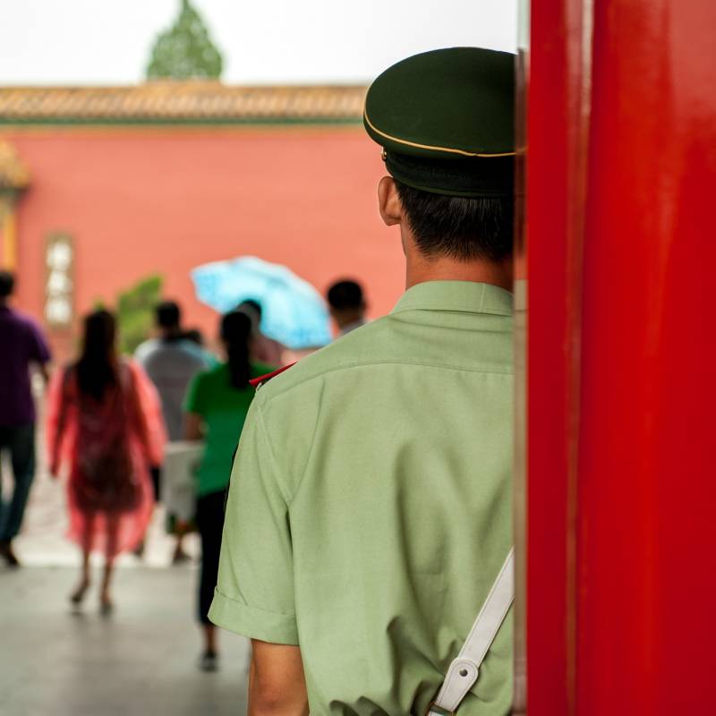 Enchanting Travels China Tours Guard standing at door entrance to the palace in China - Is China safe