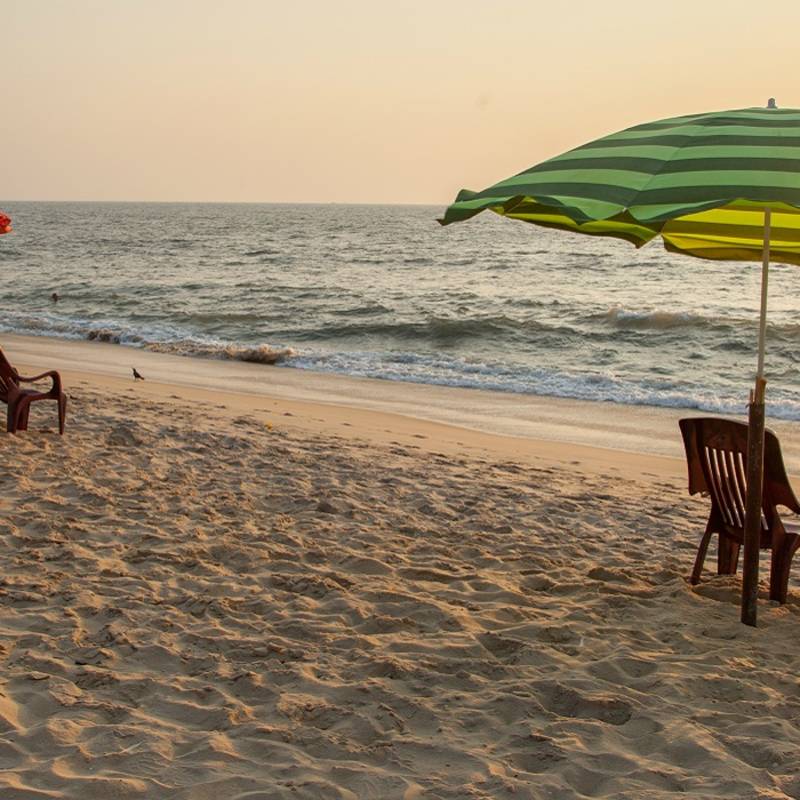 Enchanting Travels India ToursChairs and umbrella at Marari Beach, Kerala. It is one of the most popular beaches in Kerala