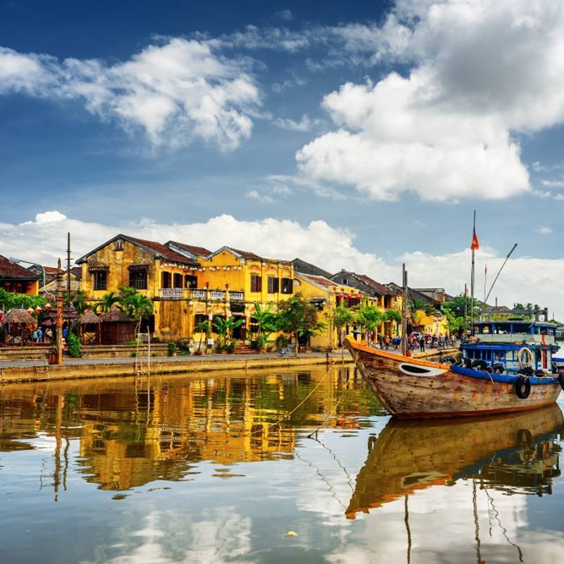 Enchanting Travels Vietnam Tours Hoi An Wooden boats on the Thu Bon River in Hoi An Ancient Town (Hoian), Vietnam.