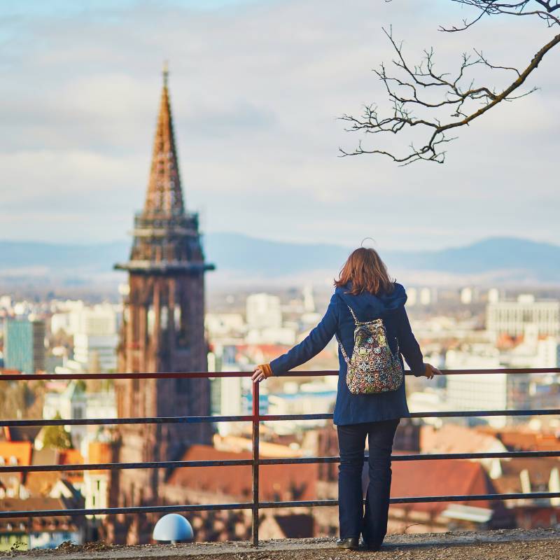 Girl enjoying beautiful panorama of Freiburg im Breisgau in Germany, Europe