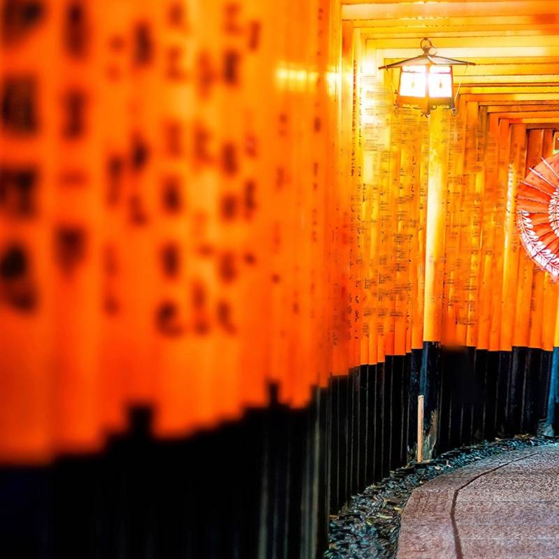 Japanese girl in Yukata with red umbrella at Fushimi Inari Shrine in Kyoto, Japan - best time to visit Japan