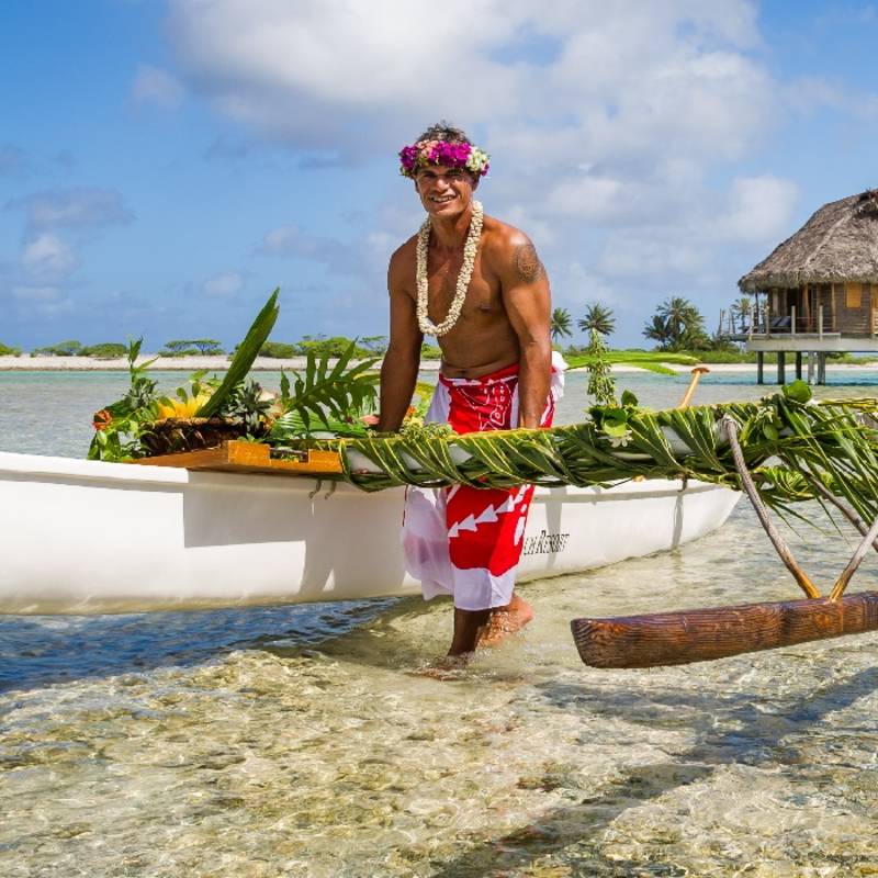 Local tahitian man was canoeing for food delivery