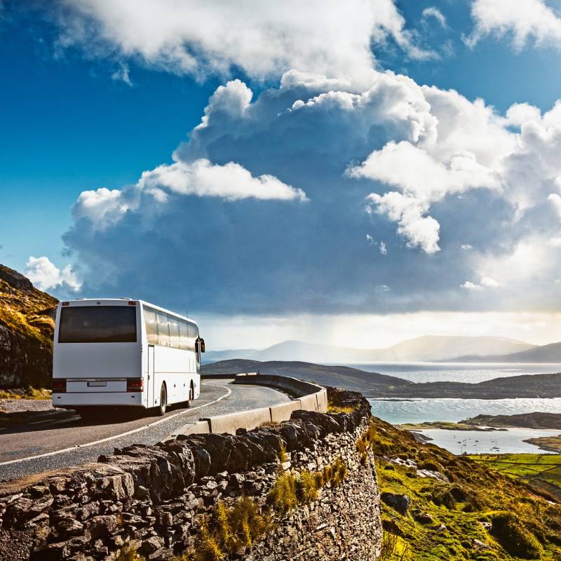 Tourist bus traveling on mountain road. Ring of Kerry, Ireland. Travel destination