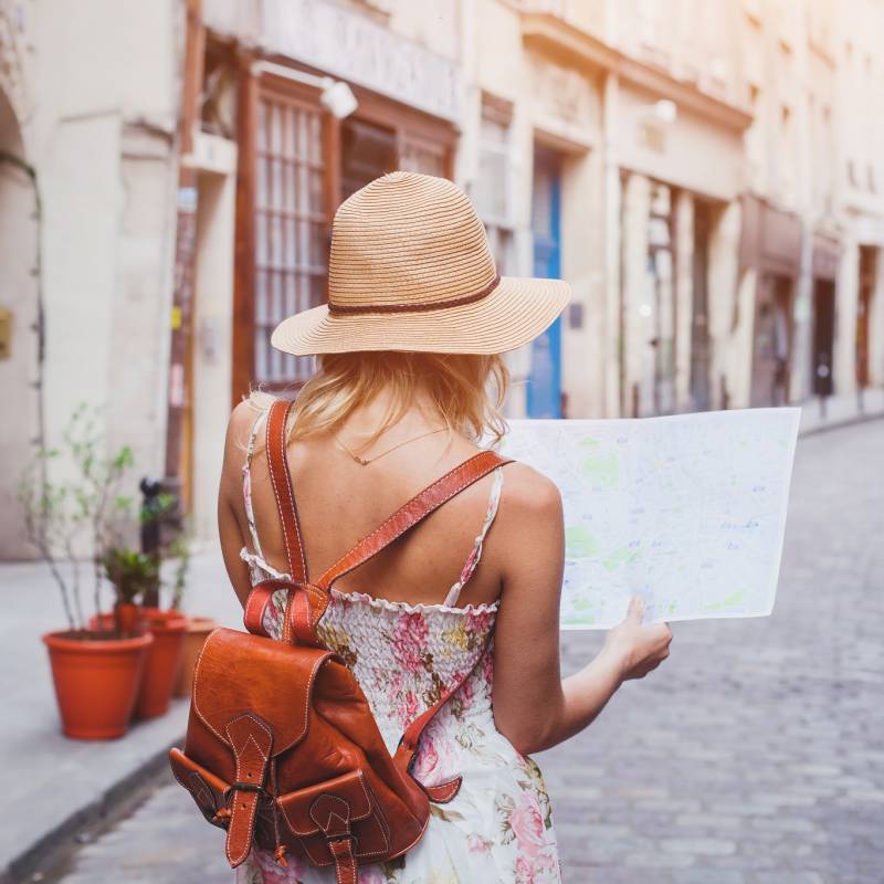 Woman tourist with map on the street, Europe