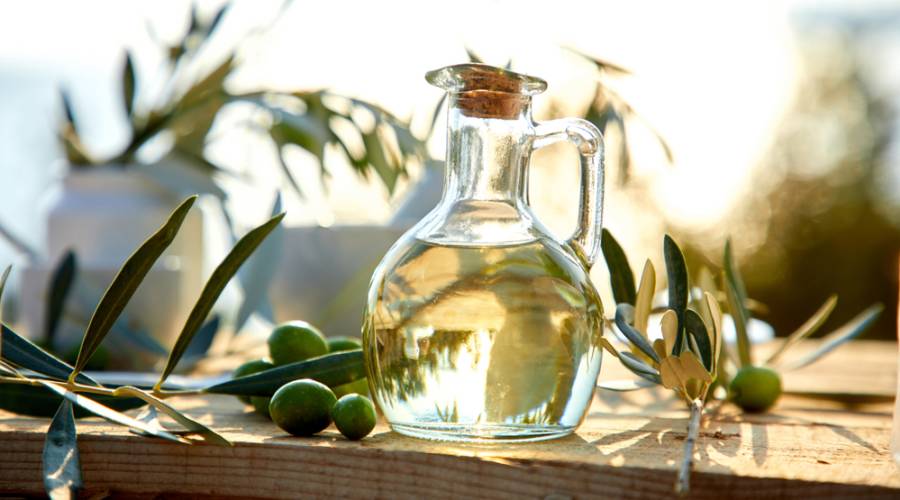 olive oil on table with leaves