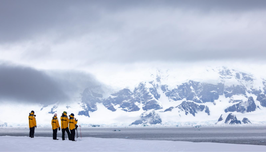 Guests in Antarctic landscape. Photo by Michelle Sole. 