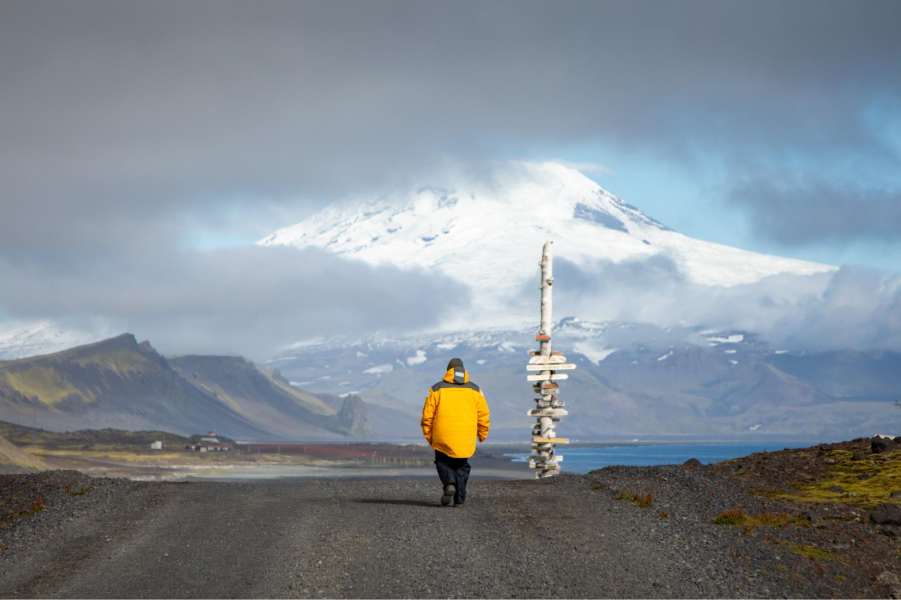 Guest walking down gravel road in Jan Mayen. Photo by Michelle Sole. 