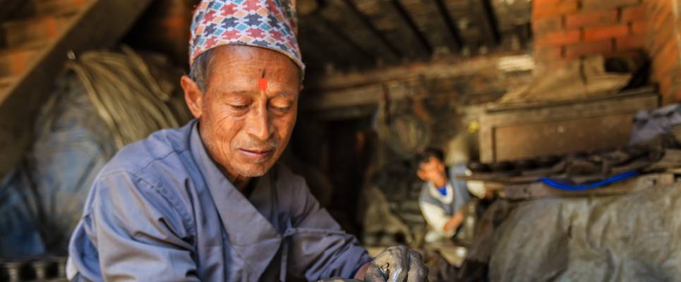 Nepalese potter working in his workshop on pottery square in Bhaktapur