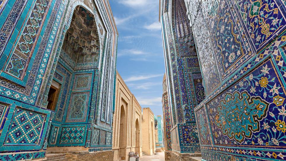 small street between blue tiled buildings