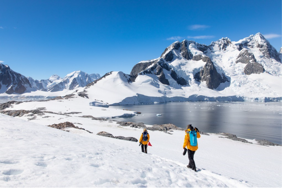 Guest hike the snowy shores of Port Charcot.