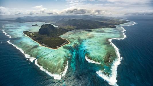 a body of water with a mountain in the background